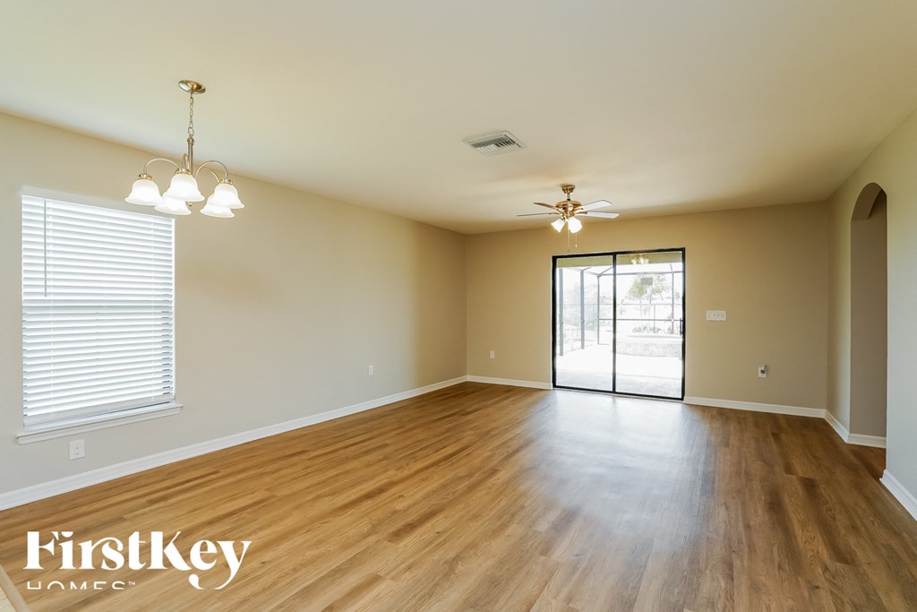 A room with wooden floors and a ceiling fan.
