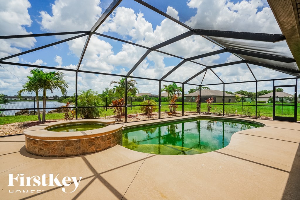 A FirstKey Homes branded image of a luxury outdoor pool area.