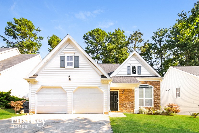 A white house with a black door and windows.