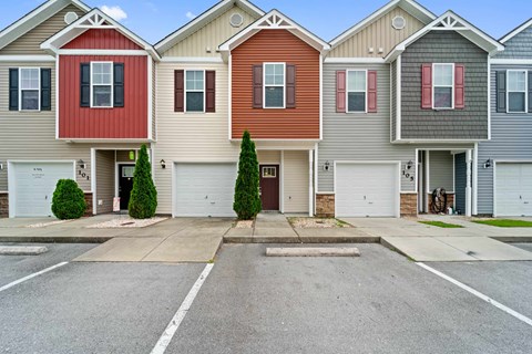 A row of houses with garages and driveways.
