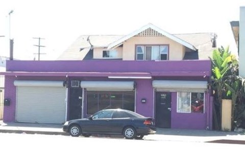 a car parked in front of a purple house