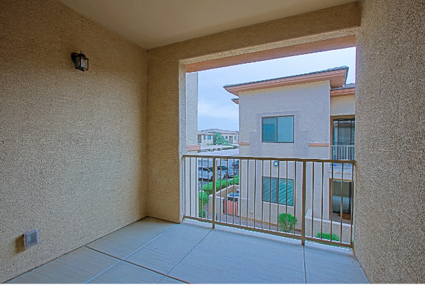 a balcony with a view of a building and a balcony fence