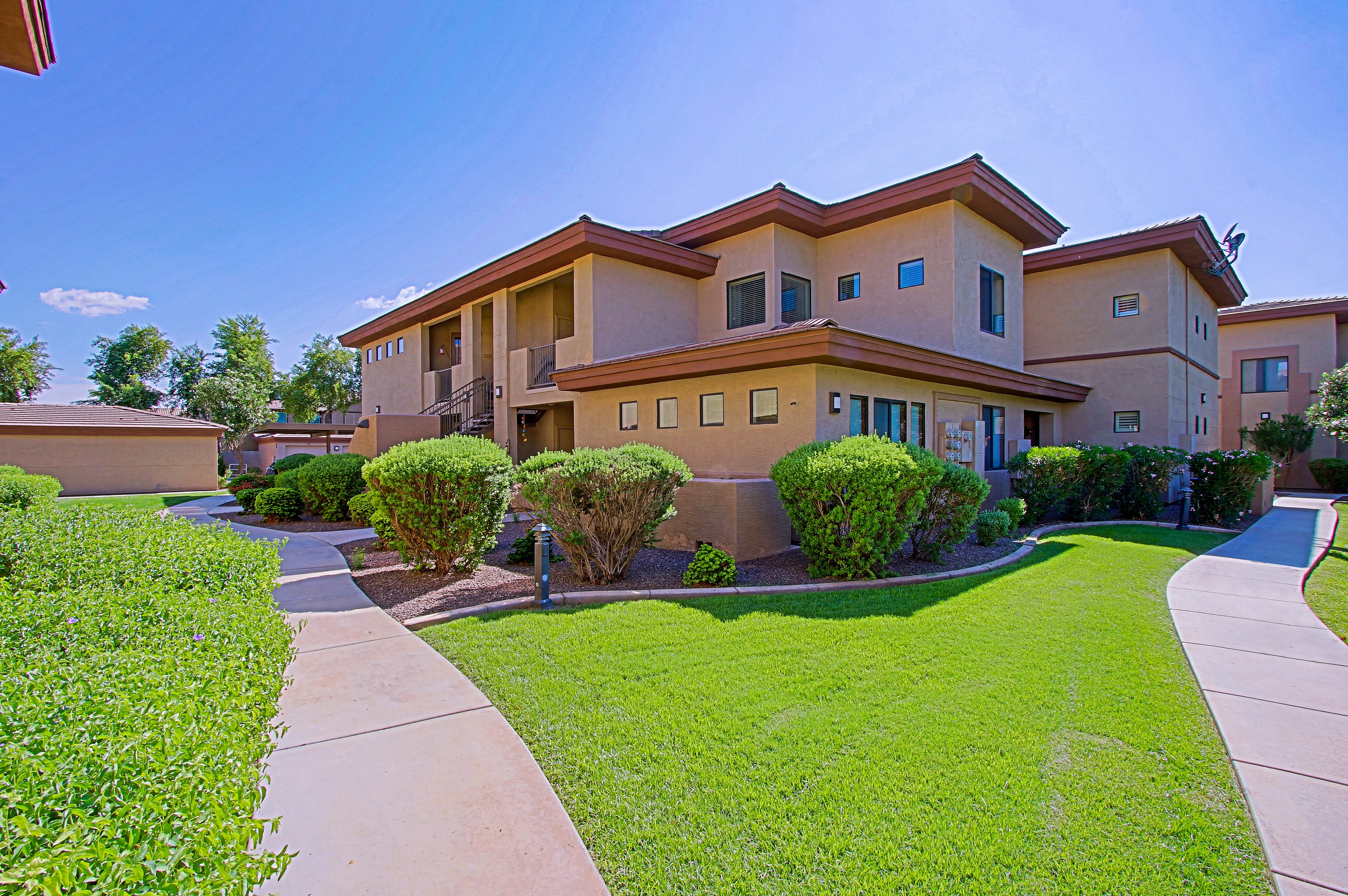 a house with a sidewalk and lawn in front of it