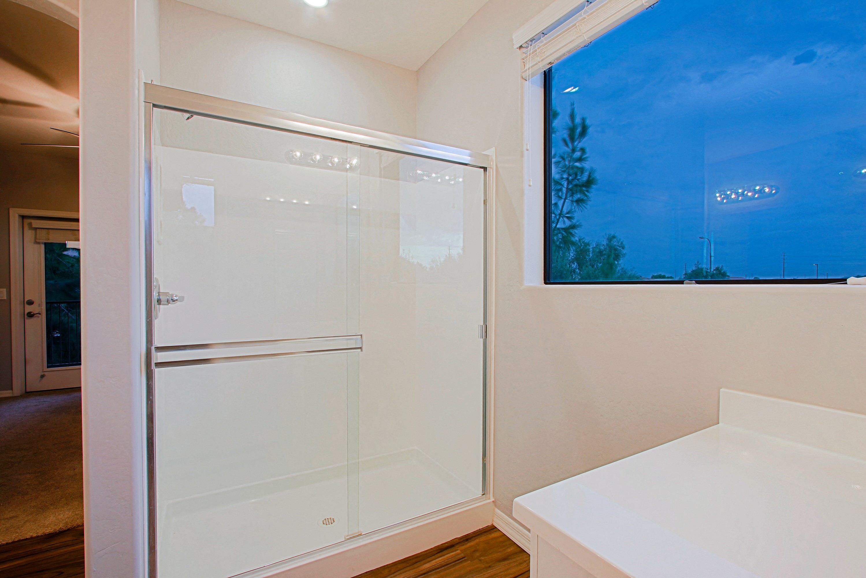 a bathroom with a shower and a window