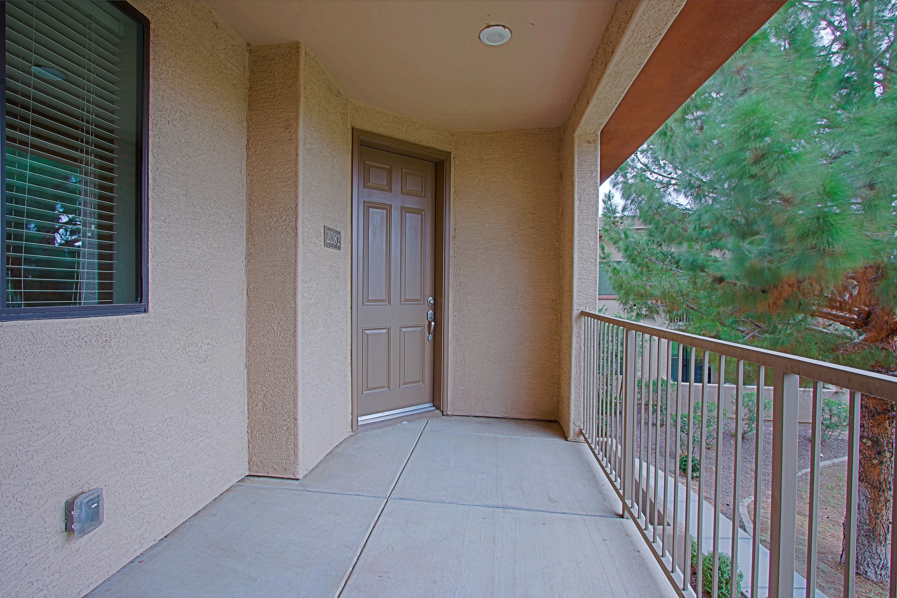 the entrance to a balcony with a door to a patio