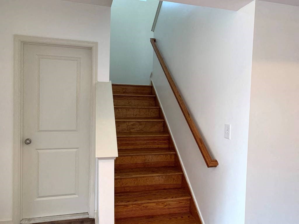 a staircase with wooden steps and a white door