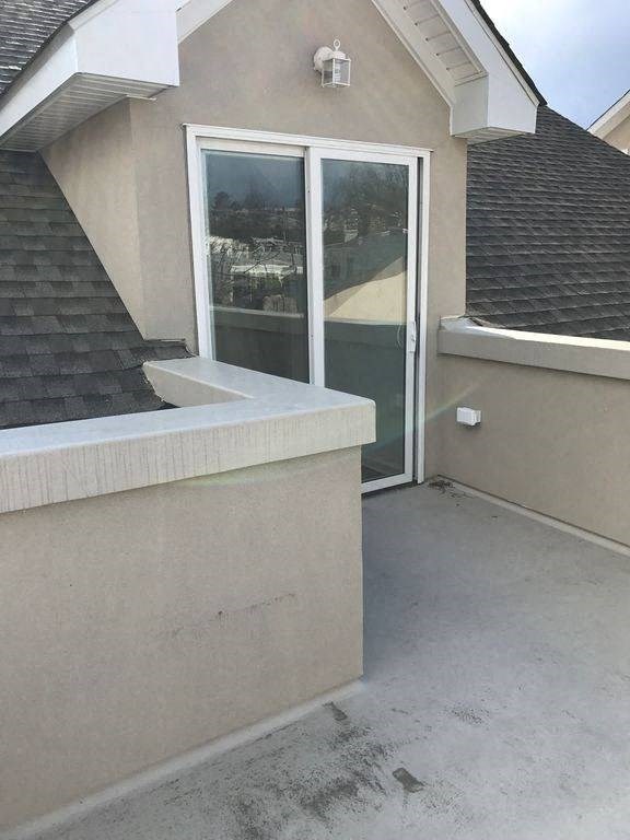 a porch with a sink and a glass door
