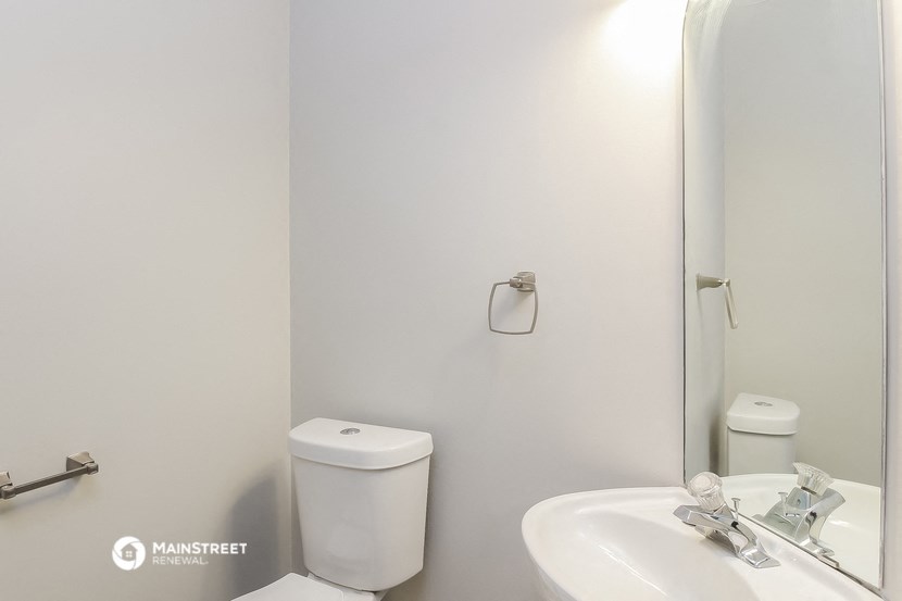 a bathroom with a sink and a toilet and a mirror