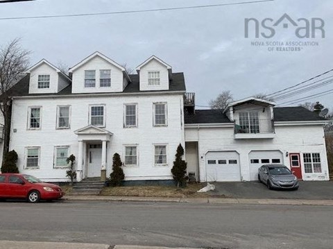 a white house on the side of a street