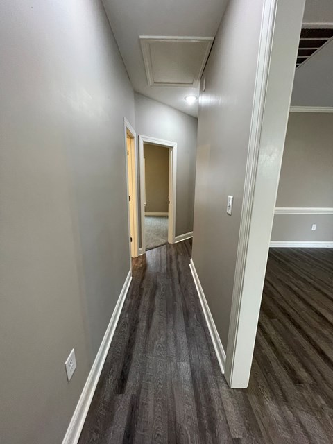 A long hallway with a door at the end.