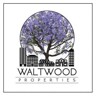 a logo for walwood properties with a tree and buildings