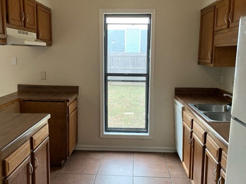 a kitchen with a sink and a window