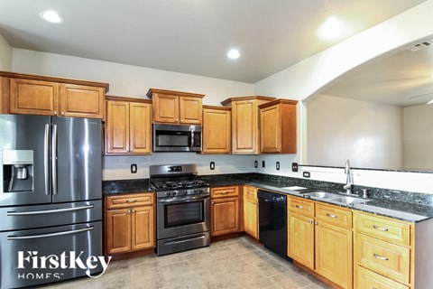 a kitchen with wooden cabinets and stainless steel appliances