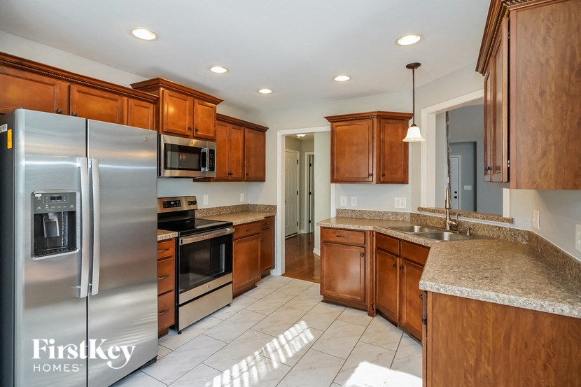 a kitchen with wooden cabinets and stainless steel appliances