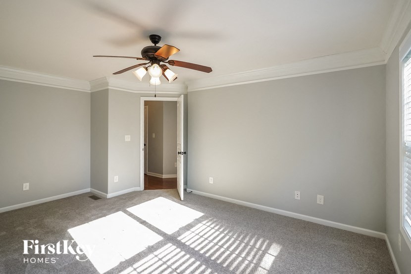 a empty living room with a ceiling fan