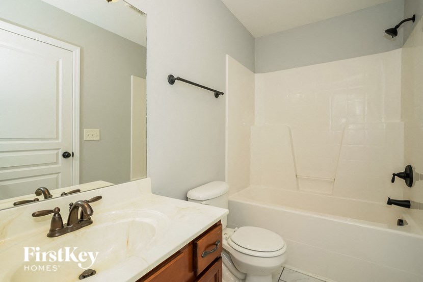 a bathroom with a sink toilet and a bath tub