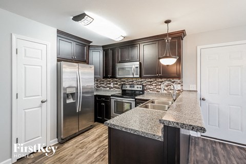 a kitchen with stainless steel appliances and granite counter tops