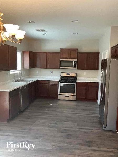 A kitchen with wooden cabinets and a white countertop.