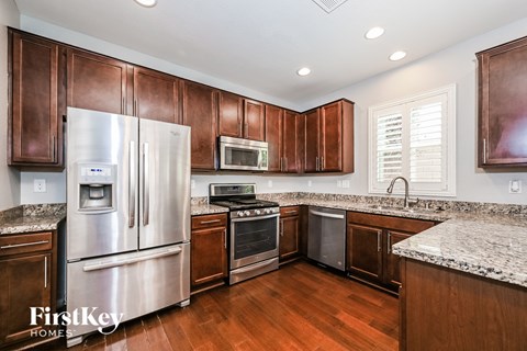 A kitchen with wooden cabinets and stainless steel appliances.