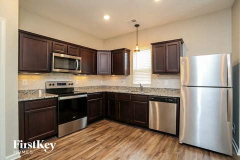 a kitchen with stainless steel appliances and granite counter tops