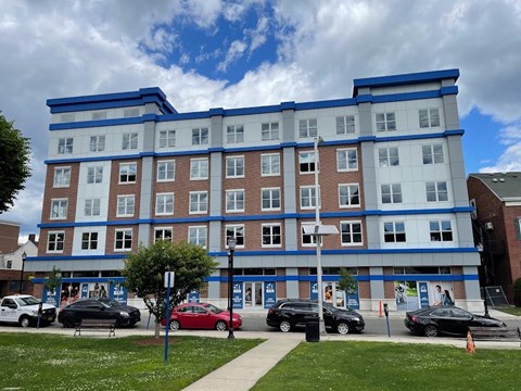 a blue and white building on the corner of a street