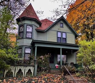 a green house with a red roof