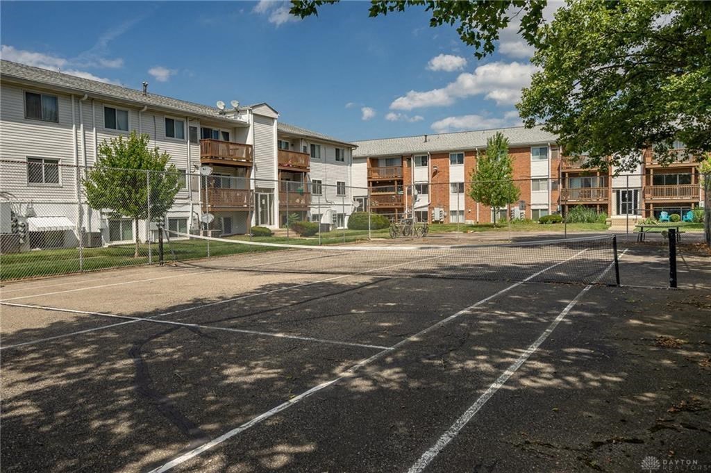 A sunny day at the apartment complex with shadows cast on the ground.