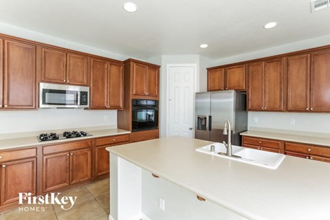 A kitchen with wooden cabinets and a white countertop.