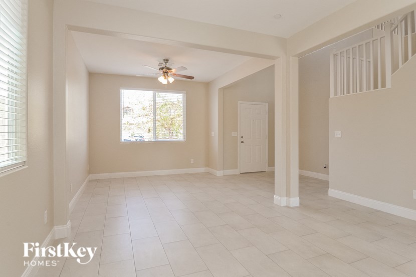 A spacious room with a ceiling fan and a window.