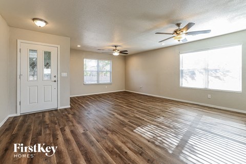 A room with wooden floors and a ceiling fan.