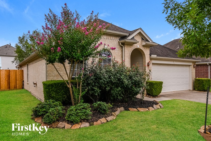 the front yard of a house with a landscaped garden