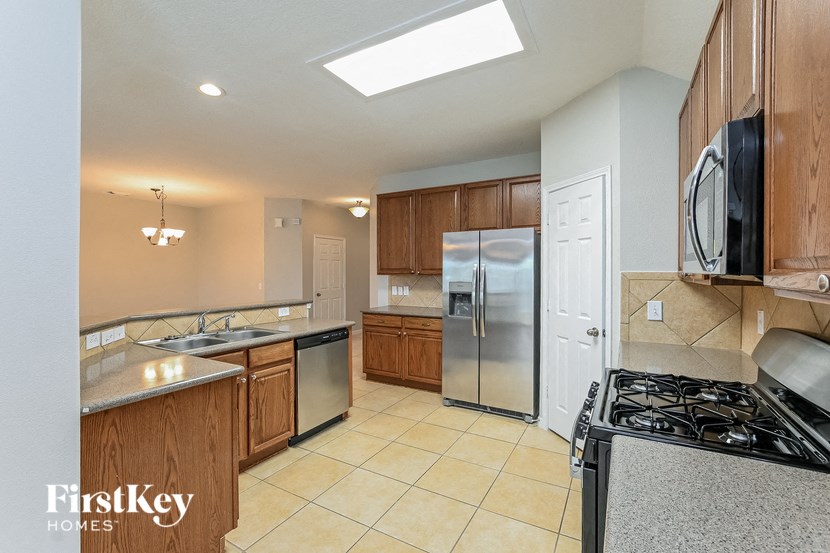 a kitchen with stainless steel appliances and wooden cabinets