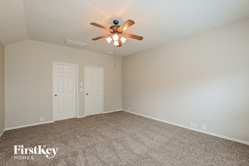 the living room of a home with a ceiling fan