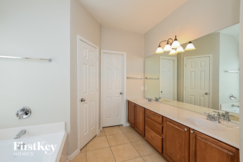 a bathroom with a sink and a mirror and a tub