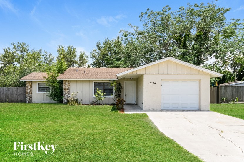 A house with a garage and a driveway is for sale.