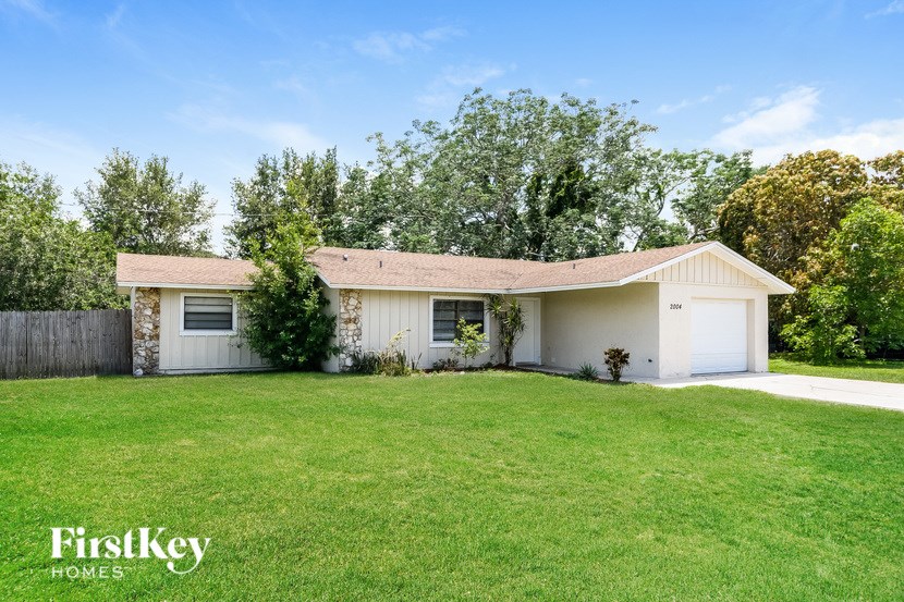 A house with a white garage door is for sale.