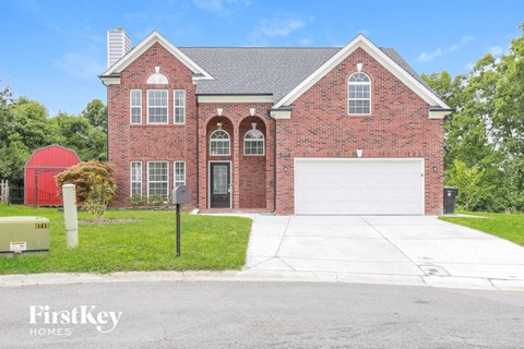 a large brick house with a white garage door