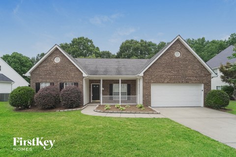 a home with a lawn and a white garage door