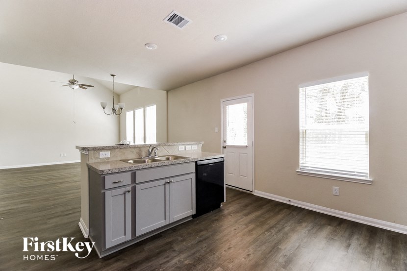an empty kitchen with a sink and a counter top