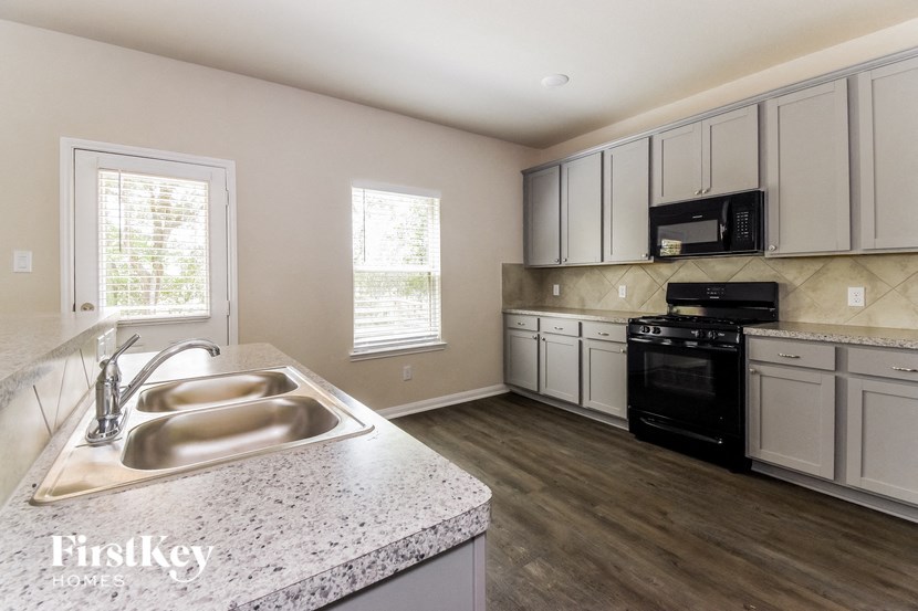a kitchen with white cabinets and a sink