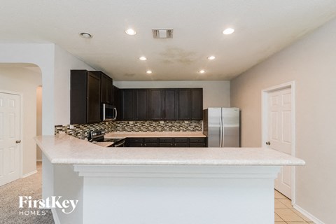 a kitchen with a counter top and a refrigerator