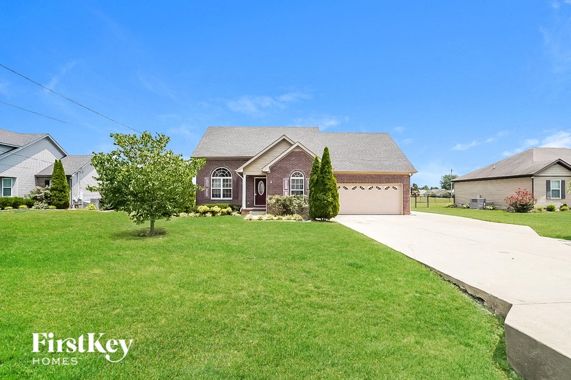 a house with a lawn and a driveway