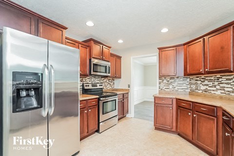 a kitchen with stainless steel appliances and wooden cabinets