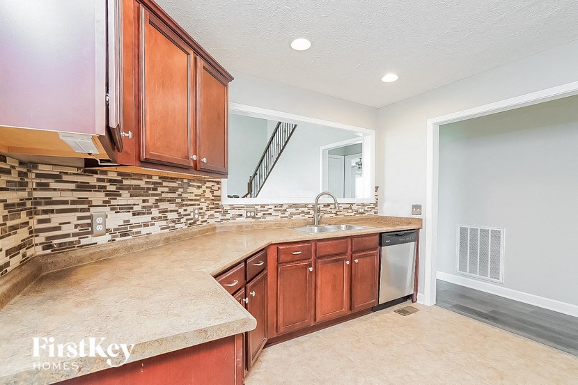 a kitchen with wooden cabinets and a sink
