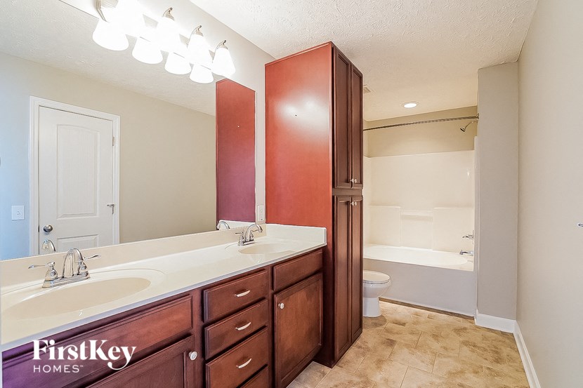 a bathroom with a sink and a toilet and a shower