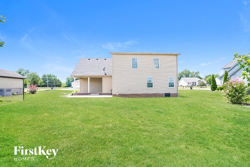 a white house with a yard and a blue sky
