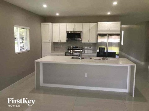 a kitchen with a large island in the middle