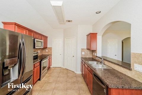 a kitchen with granite counter tops and stainless steel appliances