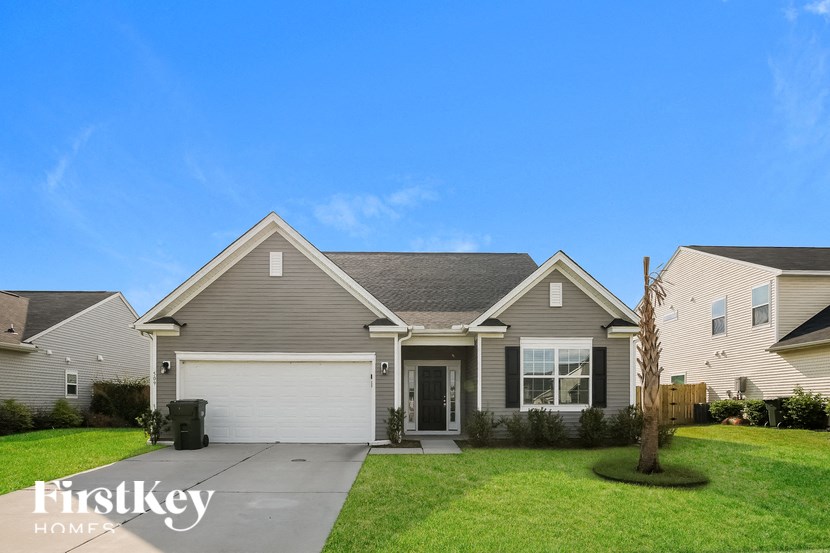 a house with a garage door and a lawn