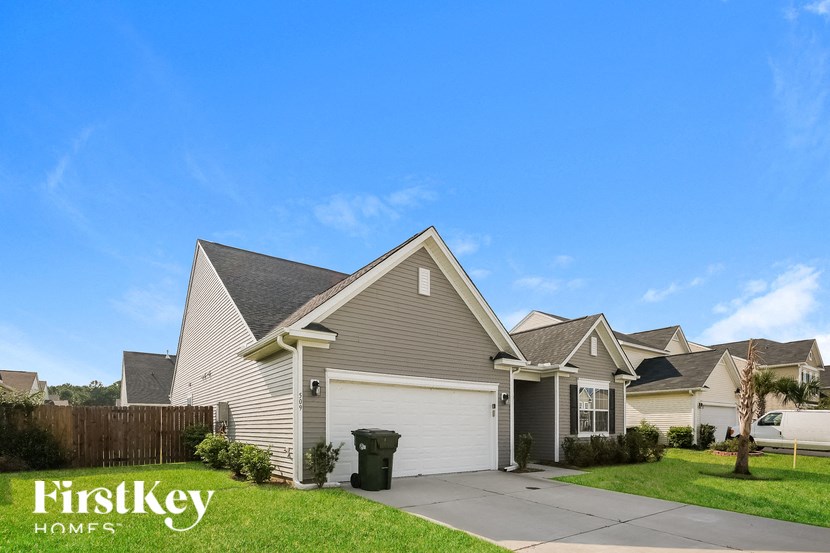 a house with a garage and a driveway in front of it